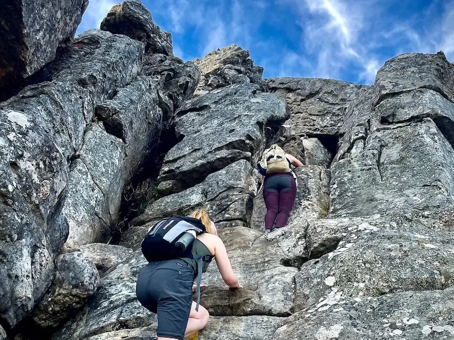 A hiker scrambling up the India Venster route on Table Mountain
